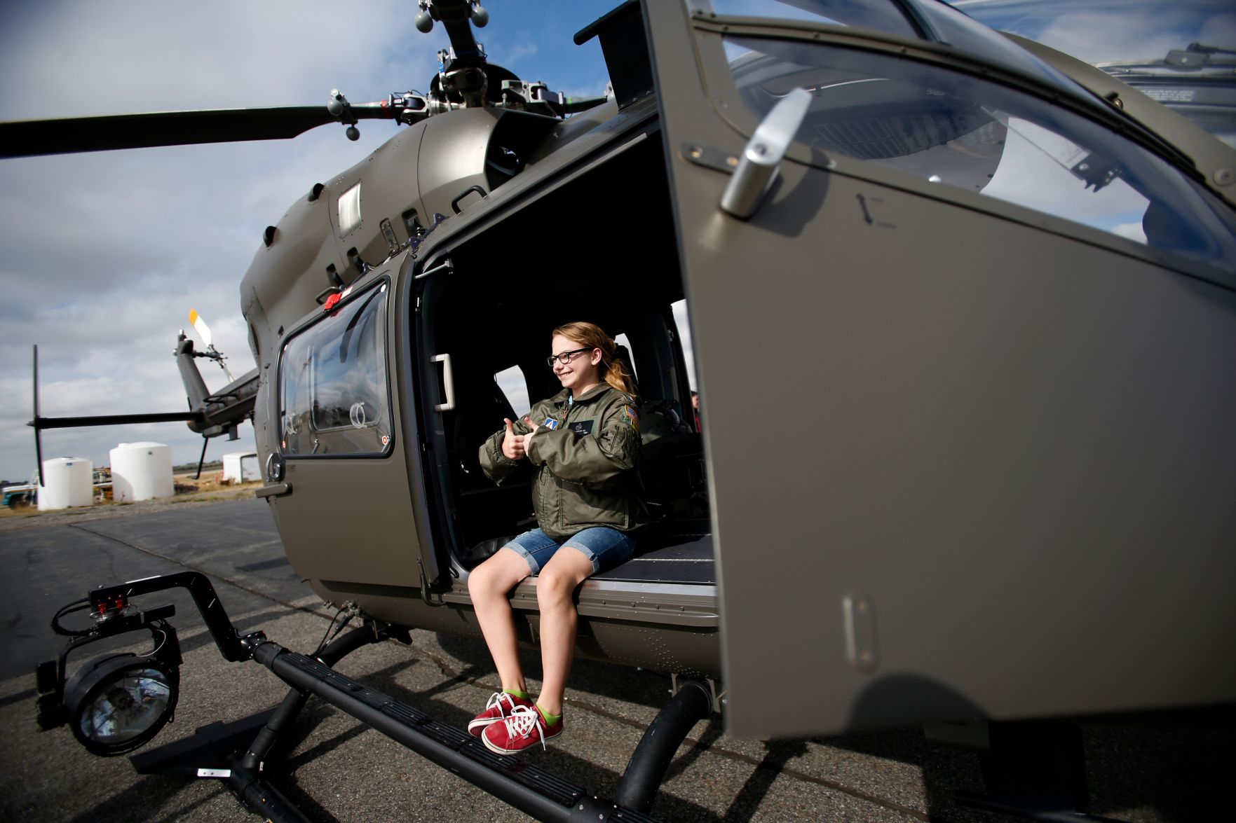 Olivia Lurker, 12, wears his father Matt's flight jacket